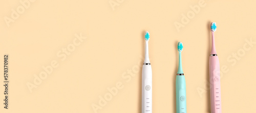Toothbrushes on a beige neutral pastel color studio background. Top View Flat Lay, Copy Space. Dental Care Supplies. Oral Hygiene Gum Health, Healthy Teeth. Modern Dental Tooth Brush Set. Clean teeth