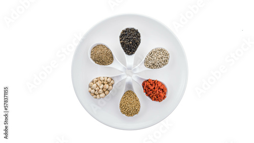 Noble herbs and spices on a spoon For cooking on white background. Asian food. Top view.