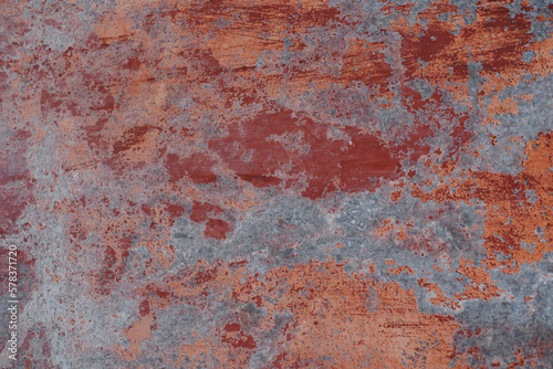Abstract grunge background. Old rusty metal. Red colors. Scratches and chips. Glare.