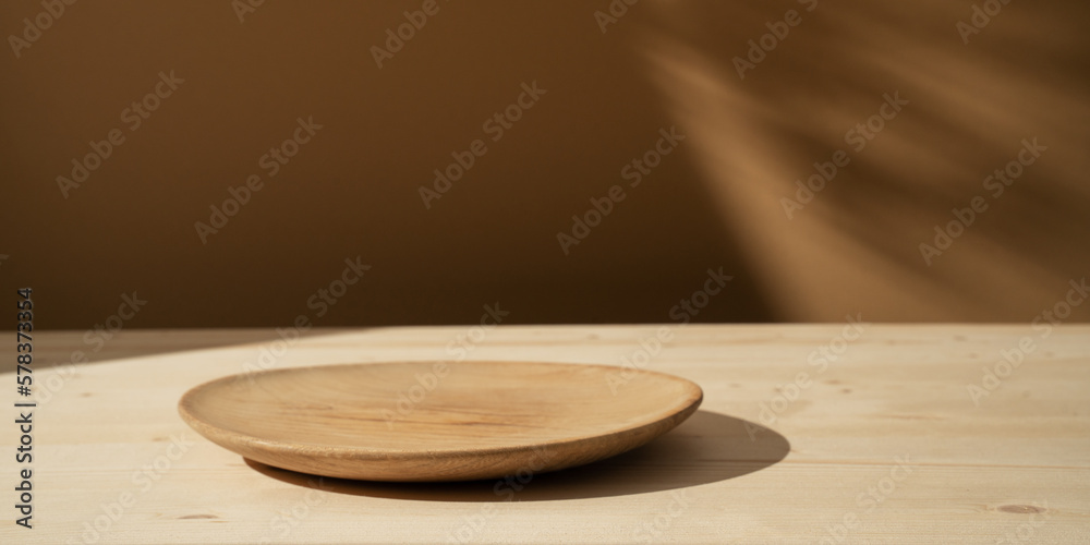 Wood flat plate mockup and shadows on the wall. Background for food products cosmetics or jewelry. Front view..