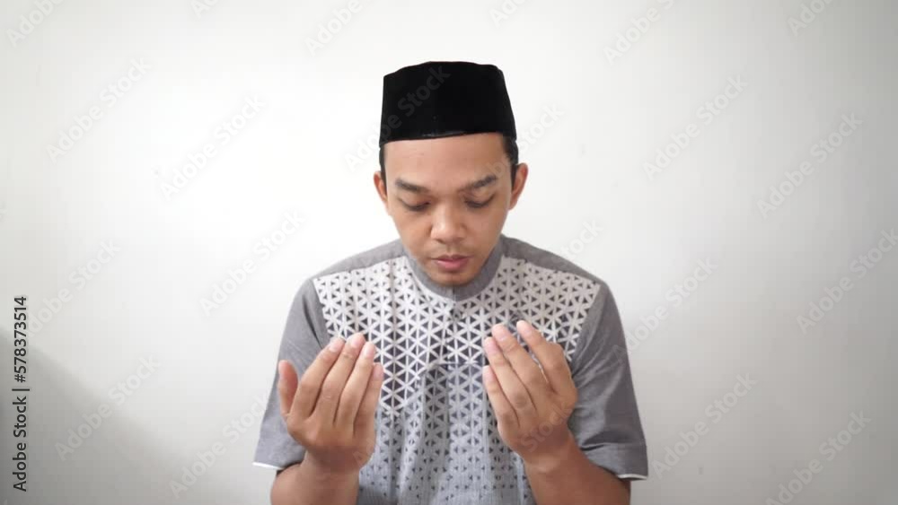 Indonesia Asian muslim men praying gesture wears black peci or songkok