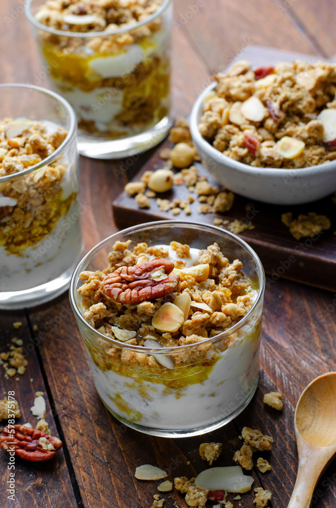 Granola and Yogurt Parfaits, Healthy Breakfast or Snack, Muesli with Nut Mix and Honey on Wooden Background Granola and Yogurt Parfaits, Healthy Breakfast or Snack, Muesli with Nut Mix and Honey on Wooden Background