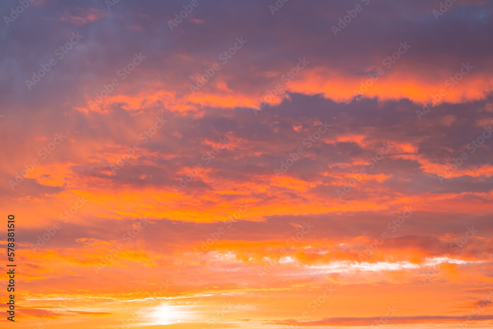 Dark orange sky with clouds at sunset. Natural natural bright background