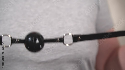 a woman holds a black ball for her mouth in her hands.close-up.slow-motion video. High quality Full HD video recording photo