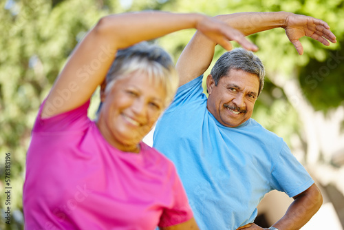 Its exercise and fun. Portrait of a mature couple exercising together in their backyard.