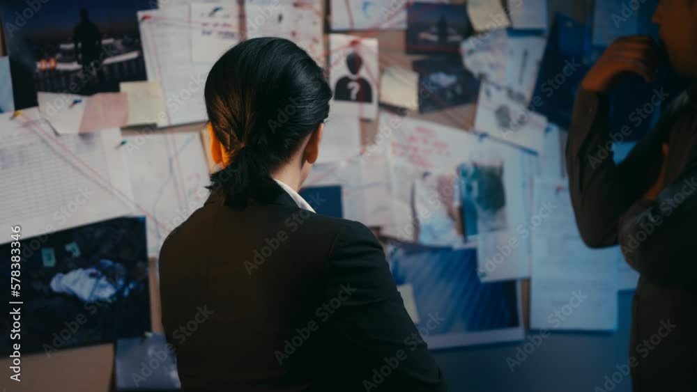 Puzzled male, female detectives looking at evidence board, trying to solve crime