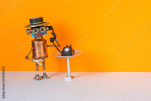 Robot bot operator holds handset rotary telephone. The concept of a hot line phone service for customer support, consultation using answering machine robots trained artificial intellect technology.