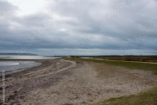 Footpath along The Solent Way trail at Lymington Hampshire England on a stormy winter day