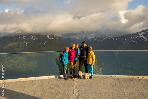 People, adult with kids and pet dog, hiking mount Hoven, enjoying the splendid view over Nordfjord from Loen skylift photo