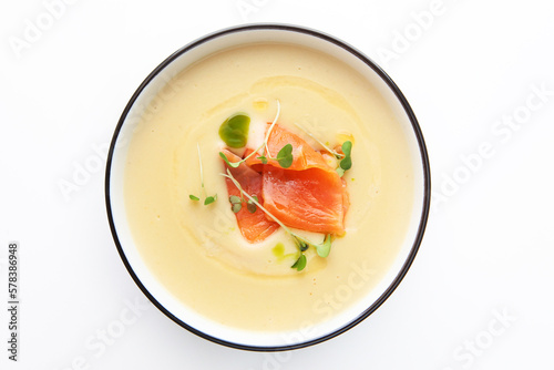 Cream soup with salmon in a white plate. Traditional French cream soup of leeks, potatoes and cream. Healthy food. p view.Copy space.