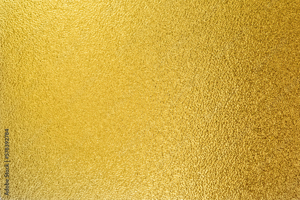 Gold wall texture background. Yellow shiny gold foil paint on wall sheet with gloss light reflection, vibrant golden luxury wallpaper Gold wall texture background. Yellow shiny gold foil paint on wall sheet with gloss light reflection, vibrant golden luxury wallpaper