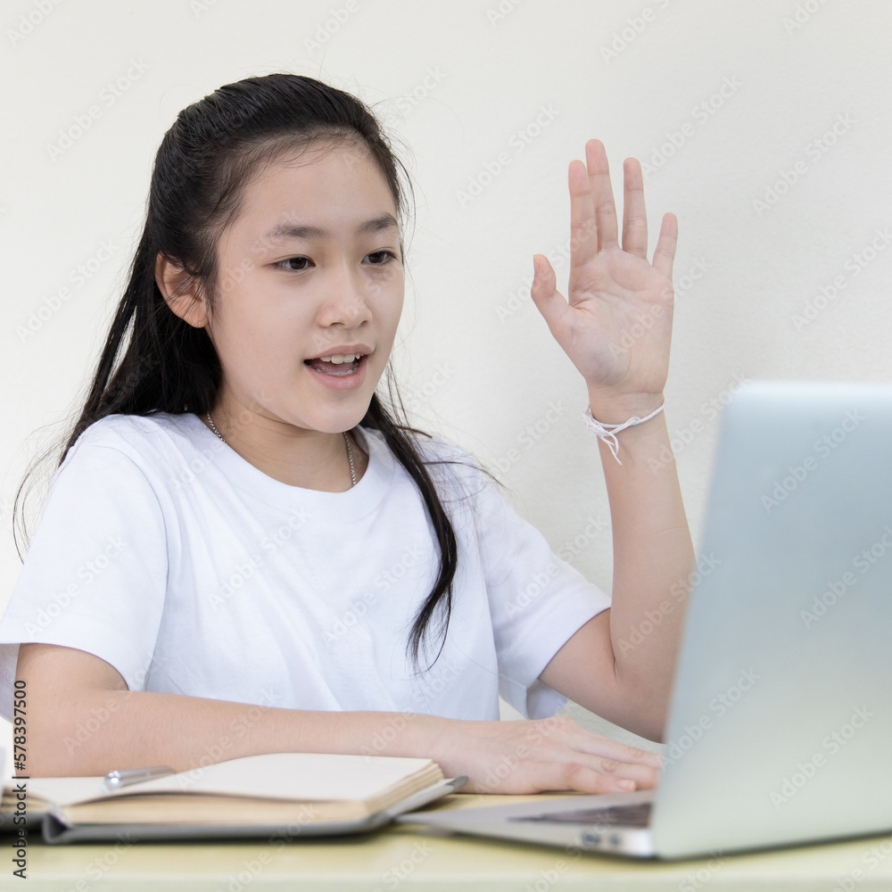 Young Asian woman is studying online and chatting with her teacher through the laptop, Online learning, stay home, New normal, Covid-19 coronavirus, Social distancing, Internet learning.. Young Asian woman is studying online and chatting with her teacher through the laptop, Online learning, stay home, New normal, Covid-19 coronavirus, Social distancing, Internet learning..