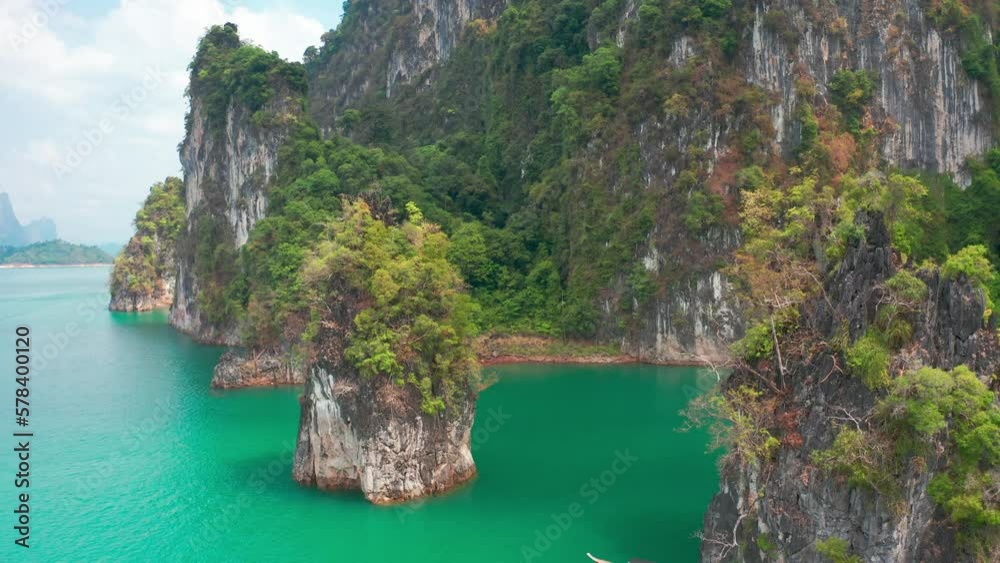 Three limestone rocks Three Brothers at Cheow Lan Lake, Khao Sok National Park, Surat Thani Province, South of Thailand. Aerial view 4K. Three limestone rocks Three Brothers at Cheow Lan Lake, Khao Sok National Park, Surat Thani Province, South of Thailand. Aerial view 4K.