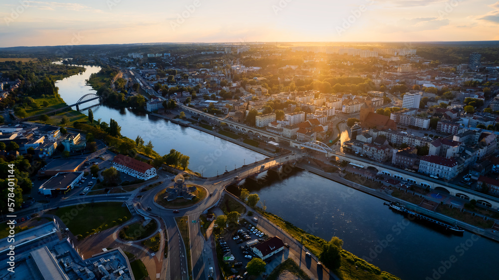 In Gorzów Wielkopolski, a drone photo was taken on a sunny day featuring the River Warta, the Cathedral, and the city center - obrazy, fototapety, plakaty 