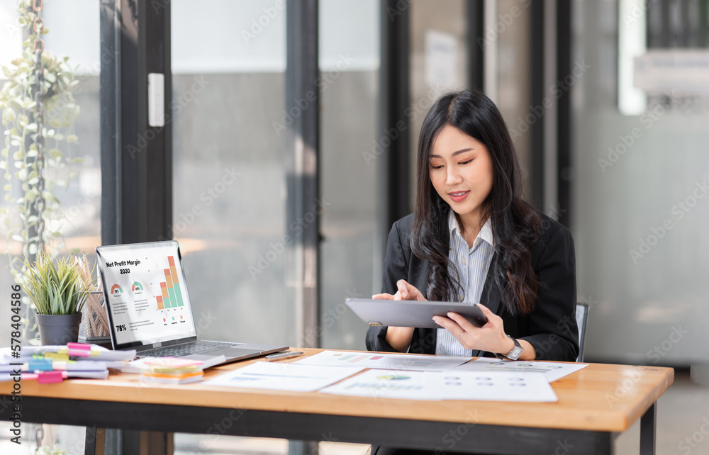 Business Asian woman working at office with documents on her desk, doing planning analyzing the financial report, business plan investment, finance analysis concept Business Asian woman working at office with documents on her desk, doing planning analyzing the financial report, business plan investment, finance analysis concept