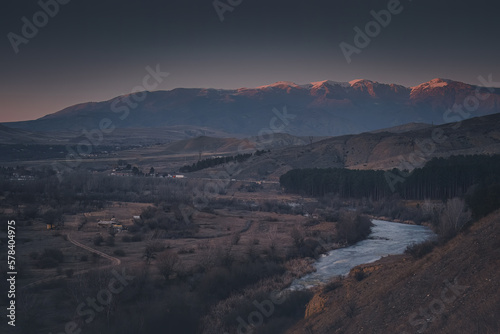 mountain landscape dusk snowy peaks and river