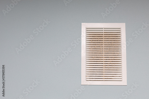 ventilation grate on the wall covered with dust.