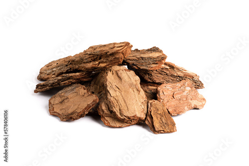 Heap of pine bark pieces isolated on white background. Pine bark chips for potting mix preparation or as organic mulch material