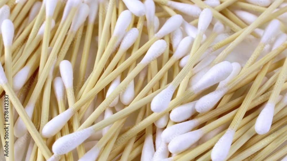 White and yellow wooden cotton swabs or bud sticks rotation close up White and yellow wooden cotton swabs or bud sticks rotation close up