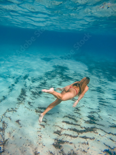 Young blonde woman in red swimsuit snorkeling in the beautiful waters of the mediterranean sea. 