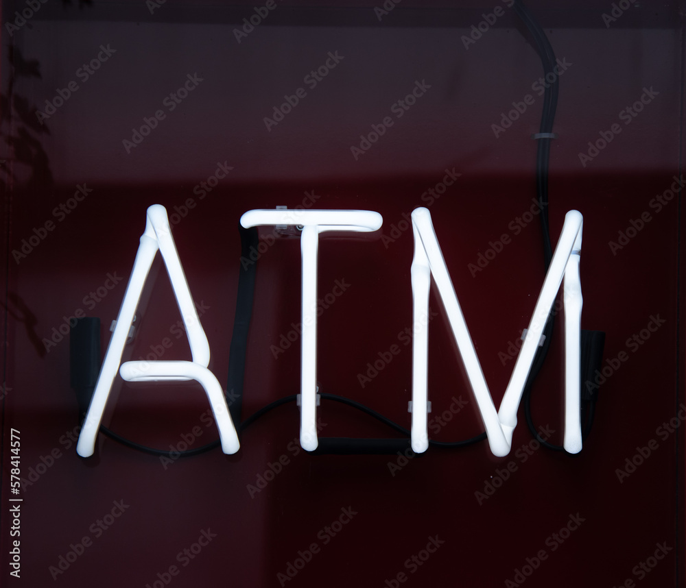 Obraz premium white neon atm sign on a shop wall