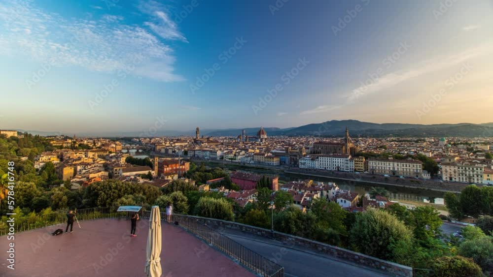 Top view of Florence city aerial panoramic timelapse at sunrise with arno river bridges and historical buildings, mountains on background. Green trees, blue cloudy sky at summer day Top view of Florence city aerial panoramic timelapse at sunrise with arno river bridges and historical buildings, mountains on background. Green trees, blue cloudy sky at summer day