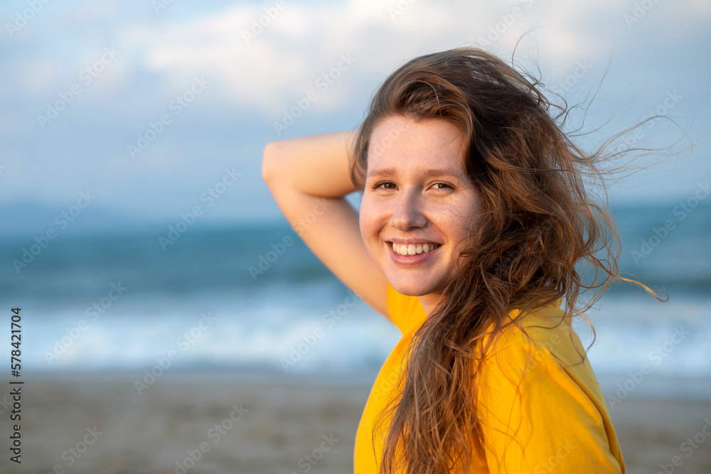 Portrait of happy girl, young carefree woman enjoying summer vacation on sea, walking on beach sand, smiling and having fun in tropical country, relaxing on nature. Summertime, happiness concept. Portrait of happy girl, young carefree woman enjoying summer vacation on sea, walking on beach sand, smiling and having fun in tropical country, relaxing on nature. Summertime, happiness concept.