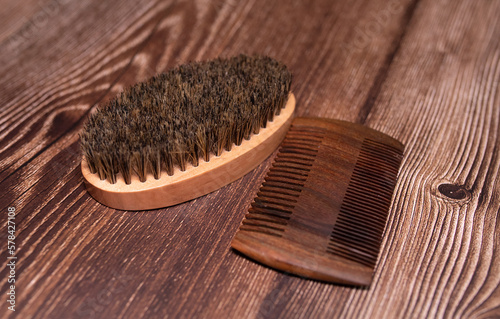 Beard kit comb and brush on wooden background. Top view. 