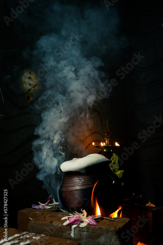 Pongal pottery in traditional stone stove with steam © Nandha Kishore