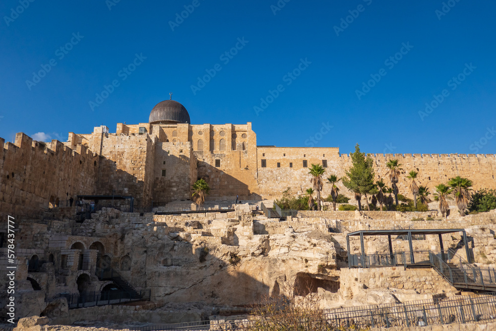 Ancient stone Western Wall under cloudless blue sky
