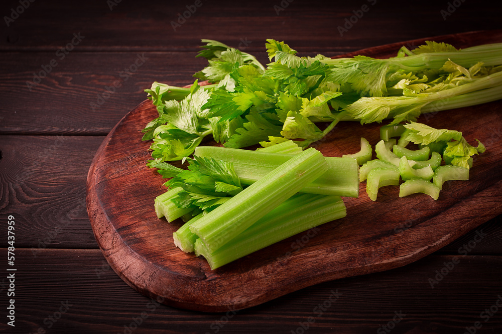 fresh bunch of celery, top view, no people, on a dark background,