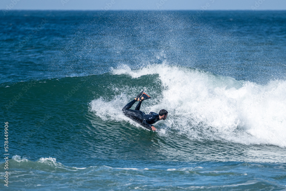 Bodyboarder surfing ocean wave