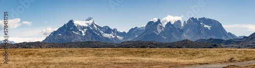 Golden Pampas and snowy mountains of Torres del Paine National Park in Chile, Patagonia, South America - Panorama