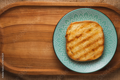 Delicious toast for breakfast on a beautiful plate on a wooden tray.