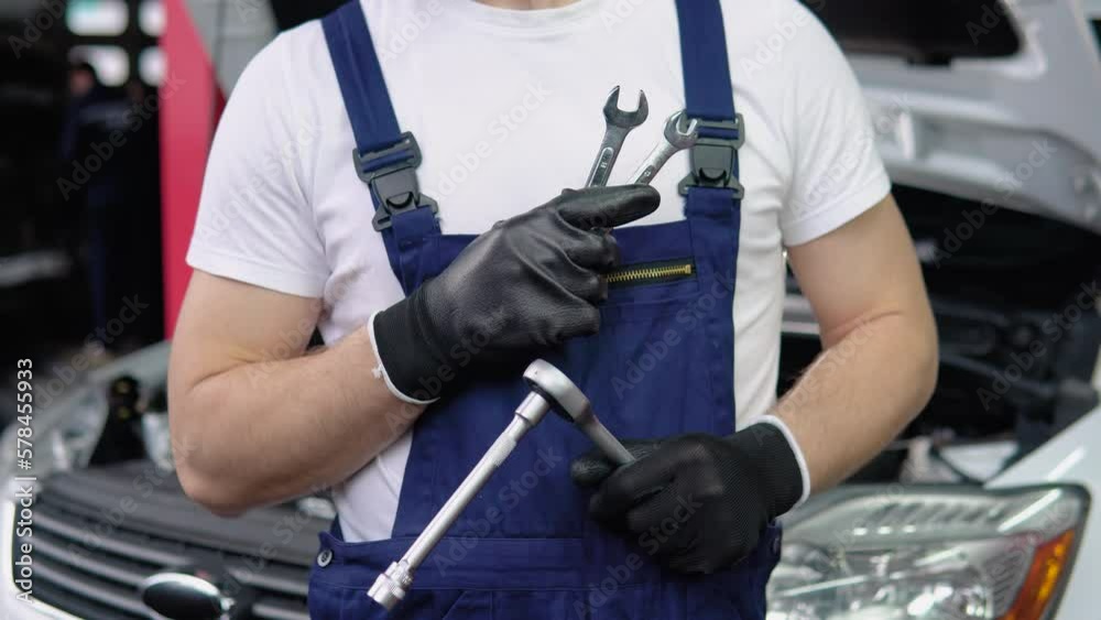 Car mechanic in garage with spanners Car mechanic in garage with spanners