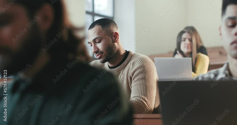 Handsome young African American male student smiling and talking with professor at college seminar. University degree concept. High school communication at lection. Guy laughing to teacher. Handsome young African American male student smiling and talking with professor at college seminar. University degree concept. High school communication at lection. Guy laughing to teacher.