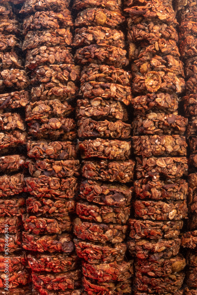 Fototapeta premium Oat and corn flakes cookies. Healthy natural food. Rows are stacked on top of each other. Vertical photo.