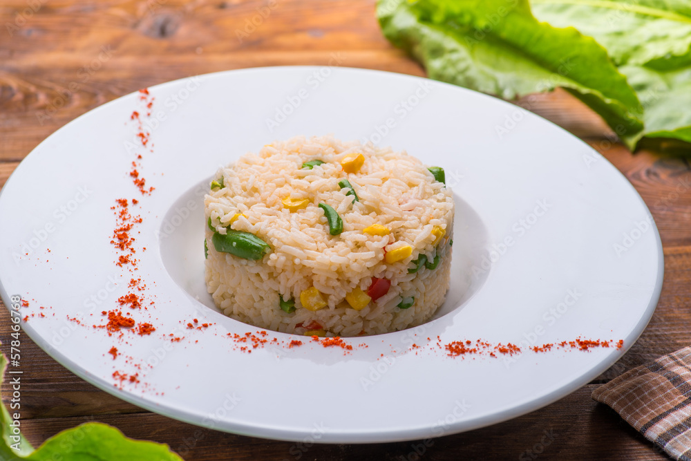 boiled rice with vegetables in a white plate