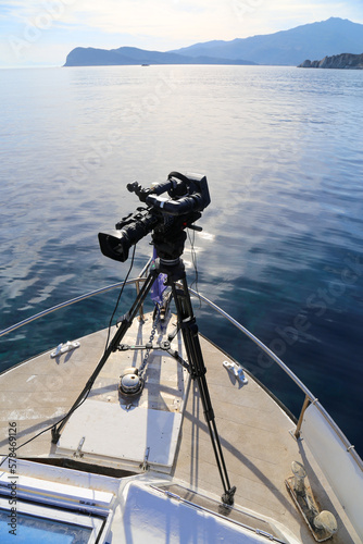 Professional camcorder on a tripod on the boat. Close-up