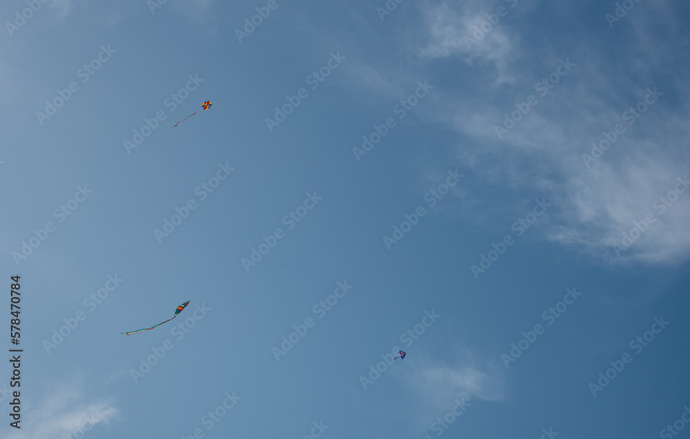 Colorful kite toy flying in the sky among clouds
