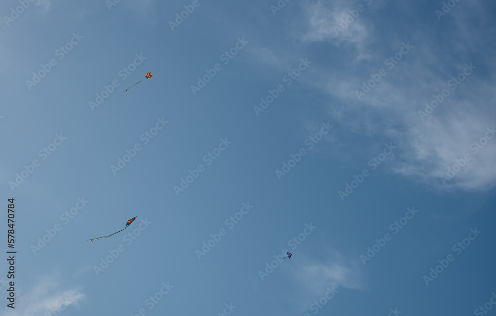Colorful kite toy flying in the sky among clouds Colorful kite toy flying in the sky among clouds