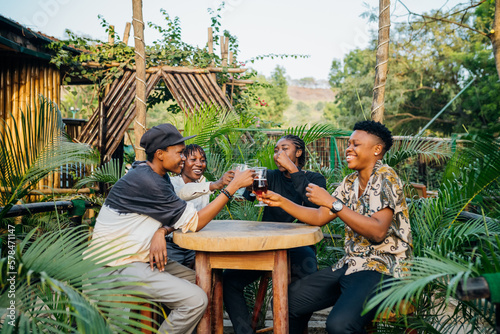 Queer masculine women having a beer in a garden