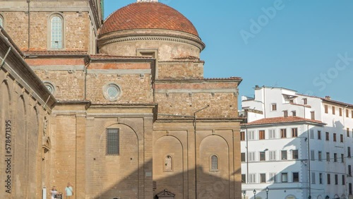 Basilica di San Lorenzo (Basilica of St Lawrence) with red dome timelapse in Florence city. Church is the burial place of all the principal members of the Medici family. Blue sky at summer morning photo