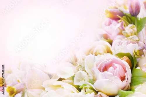 Blossoming light pink tulips  green leaves and spring flowers festive background  bright springtime bouquet floral card  selective focus  shallow DOF