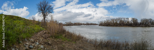 Panoramic view of the sacramento river on a cloudy spring day from levee 
