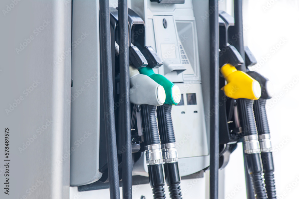 Refilling gas. Close up of man pumping gasoline fuel in car at petrol station. Refilling gas. Close up of man pumping gasoline fuel in car at petrol station.