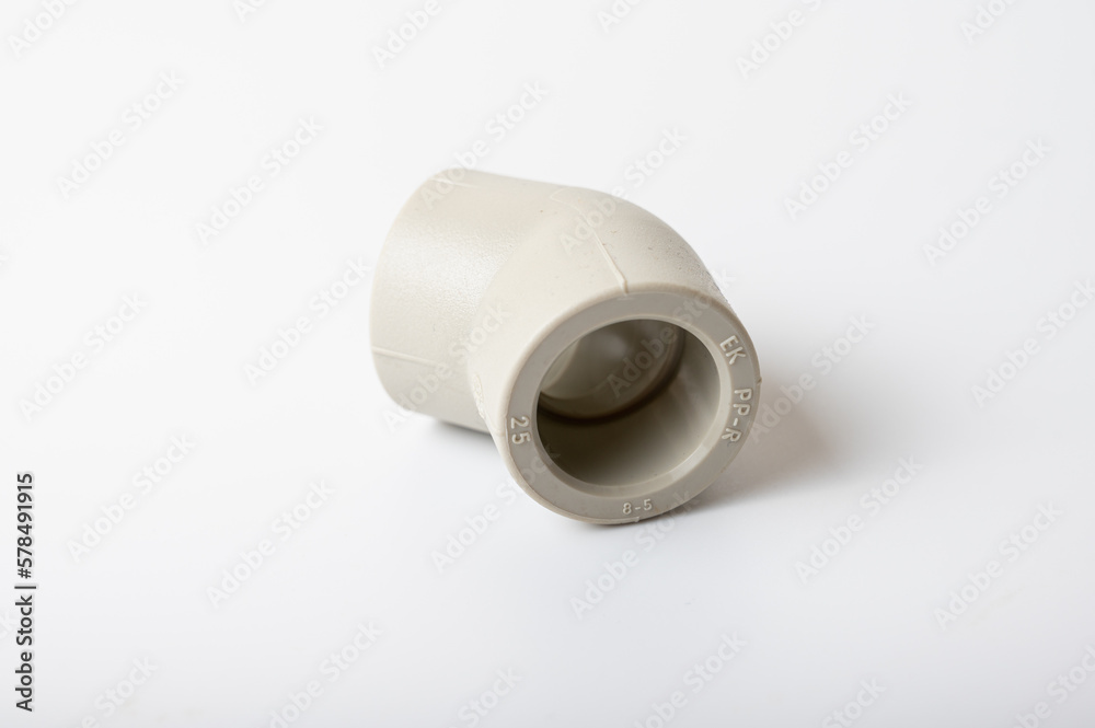 light PVC pipe tee, adapter connection for water isolated on light background, close-up light PVC pipe tee, adapter connection for water isolated on light background, close-up