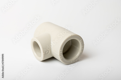 light PVC pipe tee connection for water isolated on light background close-up, connection for plumbing