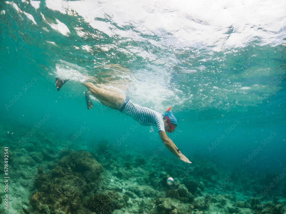 woman snorkeling in clear tropical sea