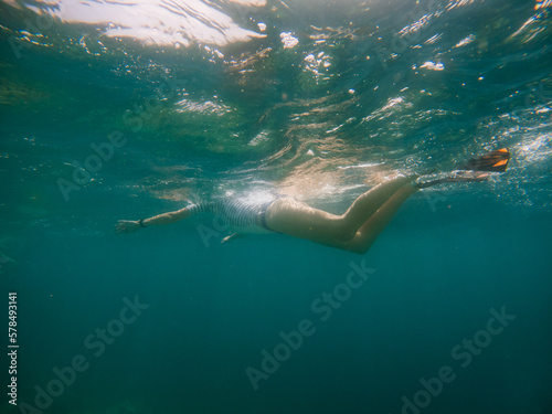 woman snorkeling in clear tropical sea